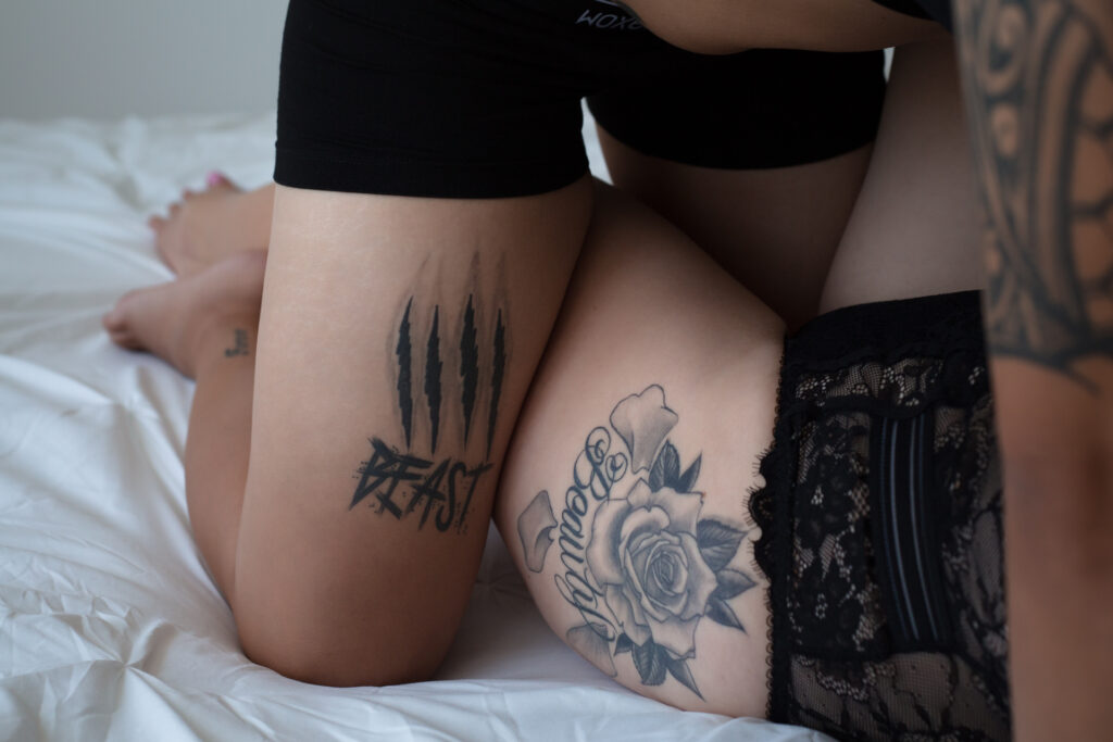 tattoos together one on each leg reads beauty and beast