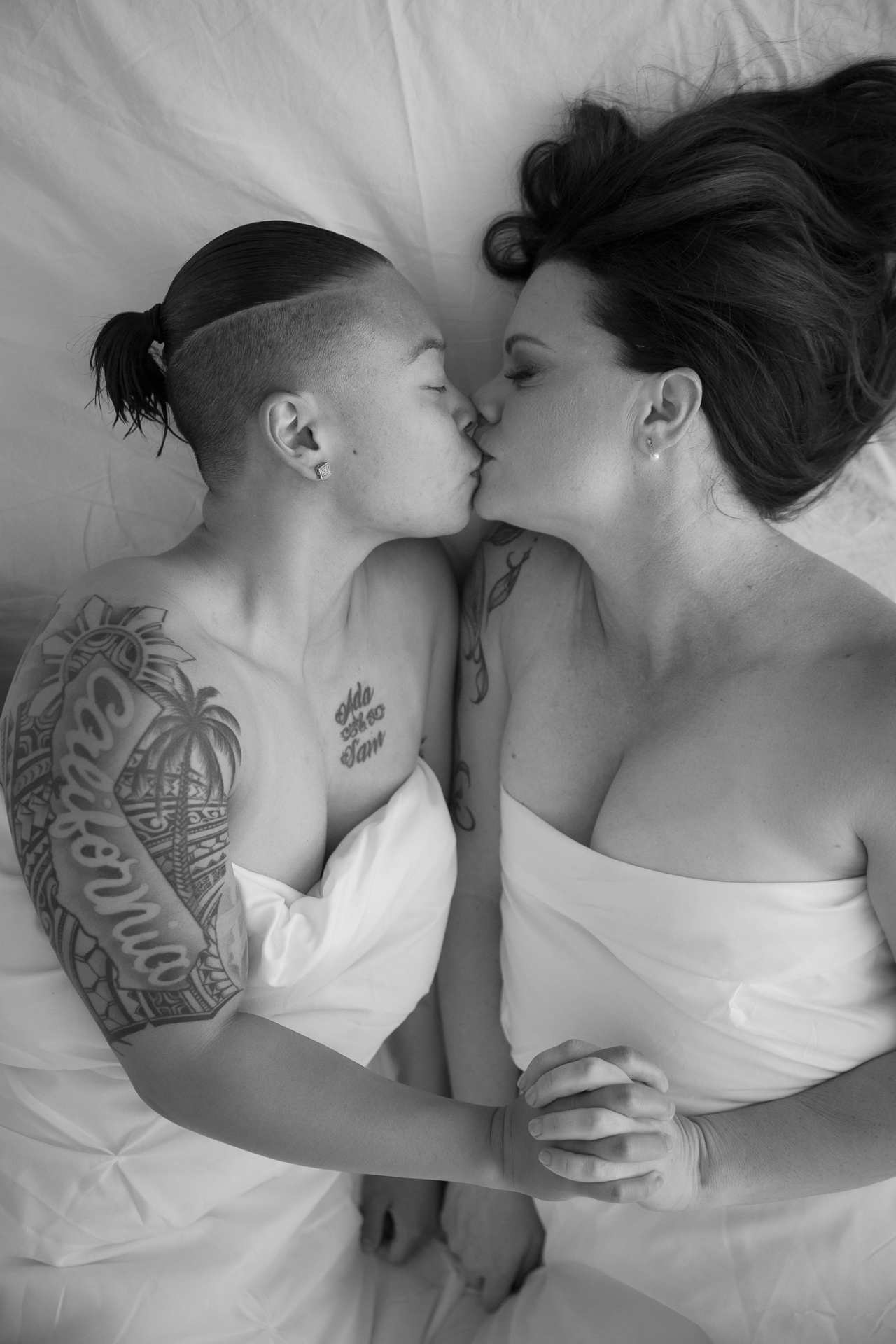 white sheet couple kissing